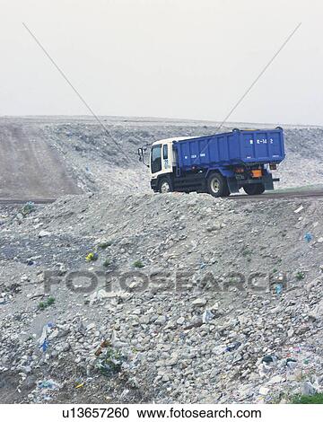 Dump Truck in landfill, low angle view View Large Photo Image Stock Image - Dump Truck in landfill, low angle view . Fotosearch