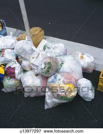Stock Photo - Garbage bags at rubbish tip, high angle view. Fotosearch