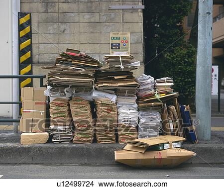 Garbage for recycling in front of sign board View Large Photo Image Picture - Garbage for recycling in front of sign board. Fotosearch