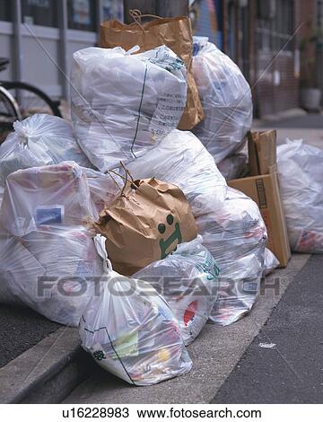 Stock Image - Pile of garbage bags, high angle view. Fotosearch
