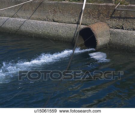 Polluted water spilling from culvert, high angle view View Large Photo Image Stock Photo - Polluted water spilling from culvert, high angle view. Fotosearch