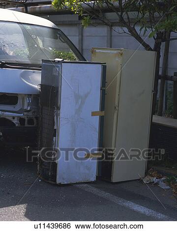 Stock Photograph - Refrigerators abandoned in front of truck. Fotosearch