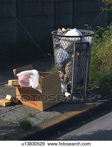 Trash can filled with garbage bags, garbage in cardboard, high angle view View Large Photo Image Stock Photo - Trash can filled with garbage bags, garbage in cardboard, high angle view. Fotosearch