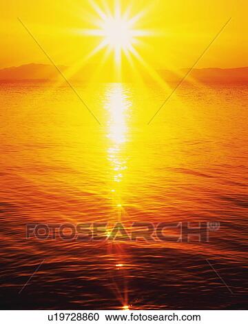 Stock Image - Sunset at the Beach, High Angle View, Pan Focus, Lens Flare. Fotosearch