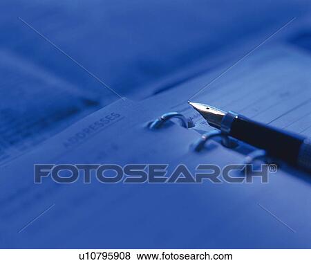 Stock Photo - A fountain pen and a scheduler, Close Up, High Angle View, Toned Image, Differential Focus. Fotosearch