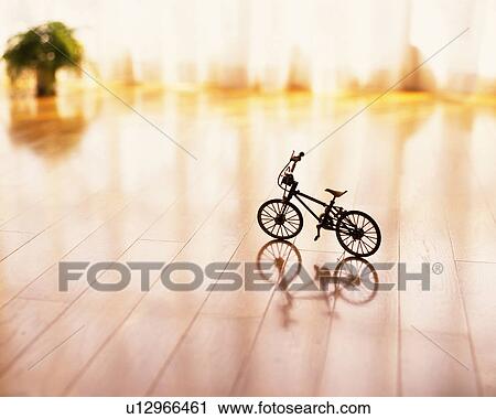 Stock Image - A toy bicycle on the floor, High Angle View, Differential Focus. Fotosearch