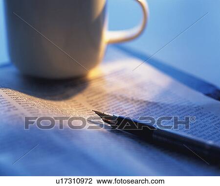 Stock Image - Cup and fountain pen on a book, Close Up, High Angle View, Differential Focus. Fotosearch