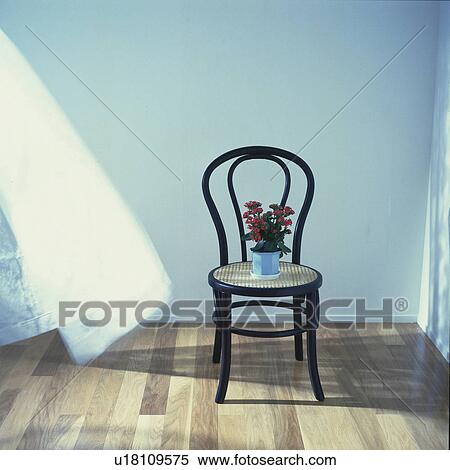 Stock Photography - Flower pot on the chair, High Angle View, Blurred Motion. Fotosearch