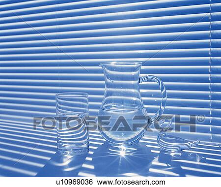 Stock Photograph - Glass and pitcher by the blind, Close Up. Fotosearch