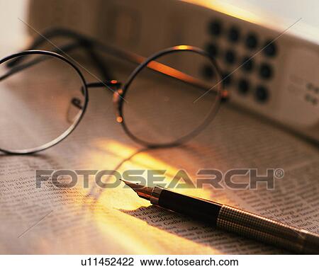 Glasses and pen on newspaper, Close Up, High Angle View, Differential Focus View Large Photo Image Stock Image - Glasses and pen on newspaper, Close Up, High Angle View, Differential Focus. Fotosearch