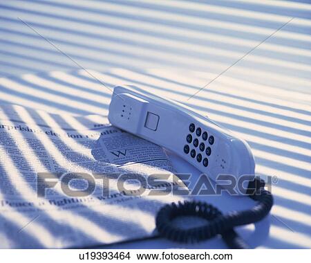 Picture - Newspaper and telephone, Close Up, High Angle View. Fotosearch