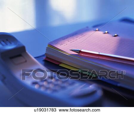 Stock Image - Scheduler and handset, Close Up, High Angle View, Differential Focus, Toned Image. Fotosearch