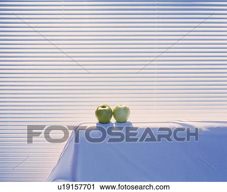 Stock Image - Two apples on the sofa, Close Up. Fotosearch