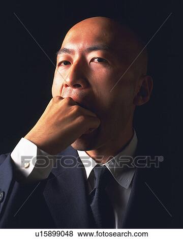 A bald headed businessman with fist in mouth, Front View View Large Photo Image Stock Photo - A bald headed businessman with fist in mouth, Front View. Fotosearch
