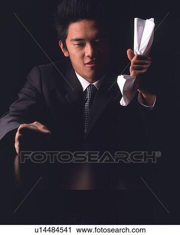 A businessman crushing paper in hand, Front View View Large Photo Image Stock Image - A businessman crushing paper in hand, Front View. Fotosearch