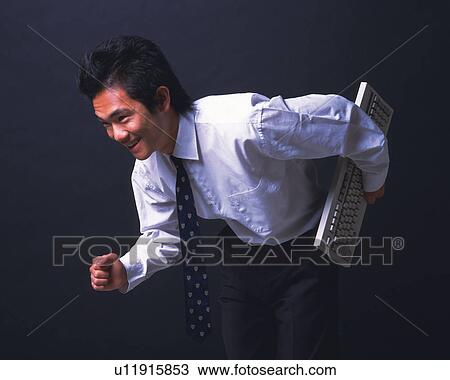 A businessman holding a keyboard and running, Side View View Large Photo Image Stock Image - A businessman holding a keyboard and running, Side View . Fotosearch