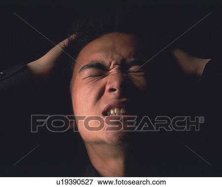 Stock Photo - A businessman struggling and tearing out hair, Close Up, Front View. Fotosearch