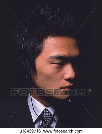 A businessman wearing a headset, Side View View Large Photo Image Stock Photograph - A businessman wearing a headset, Side View. Fotosearch