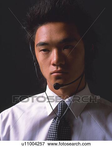 A businessman with a headset on, Front View View Large Photo Image Stock Photo - A businessman with a headset on, Front View. Fotosearch