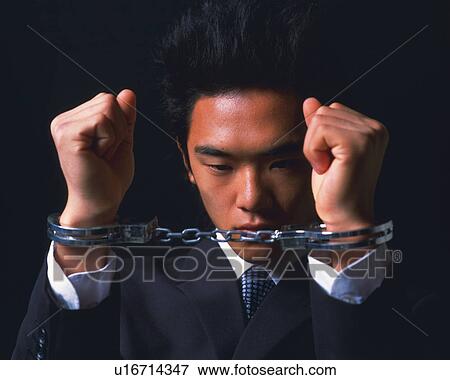 A businessmen in handcuffs, Front View View Large Photo Image Stock Photo - A businessmen in handcuffs, Front View. Fotosearch