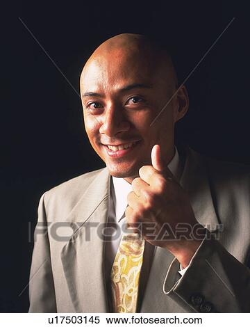A smiling bald headed businessman holding thumb up, Front View View Large Photo Image Stock Photography - A smiling bald headed businessman holding thumb up, Front View. Fotosearch