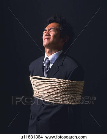 A tied up businessman, Side View View Large Photo Image Picture - A tied up businessman, Side View. Fotosearch