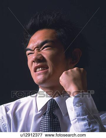 An angry businessman with fist, Low Angle View View Large Photo Image Stock Photo - An angry businessman with fist, Low Angle View. Fotosearch