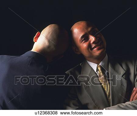 Stock Photo - Two bald headed businessmen against each other's head and smiling, Front View, Rear View. Fotosearch