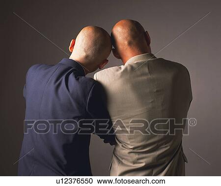 Two bald headed businessmen leaning on each other, Rear View View Large Photo Image Stock Image - Two bald headed businessmen leaning on each other, Rear View. Fotosearch
