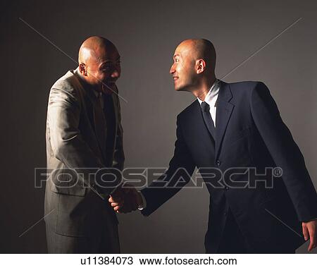 Two bald headed businessmen shaking hands, Side View View Large Photo Image Stock Image - Two bald headed businessmen shaking hands, Side View. Fotosearch