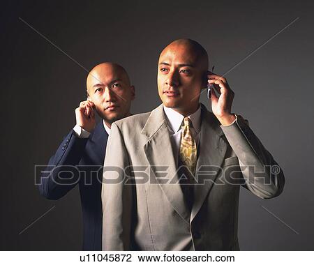 Two bald headed businessmen talking on mobile phones, Front View View Large Photo Image Stock Image - Two bald headed businessmen talking on mobile phones, Front View. Fotosearch