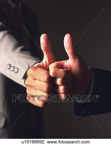 Two businessmen holding thumbs up, Close Up View Large Photo Image Stock Image - Two businessmen holding thumbs up, Close Up. Fotosearch