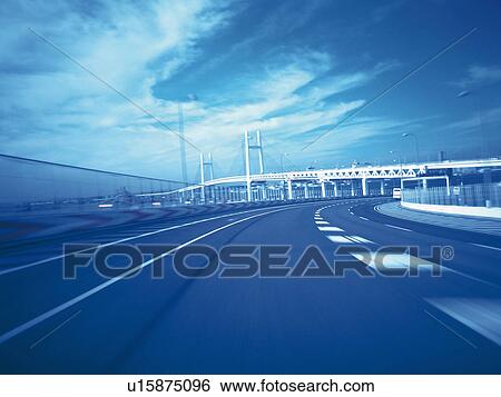 Stock Photograph -  a Highway and a White Bridge Visual in the Background, Blurred Motion, Toned Image. Fotosearch