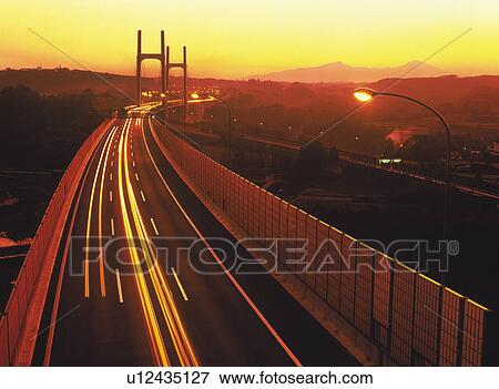 a Highway By Sunset, Surrounded By Several Mountains, High Angle View, Long Exposure View Large Photo Image Stock Photo - a Highway By Sunset, Surrounded By Several Mountains, High Angle View, Long Exposure. Fotosearch