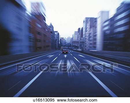 Stock Photography -  a Highway, Surrounded By a Lot of Buildings, Front view, Blurred Motion. Fotosearch