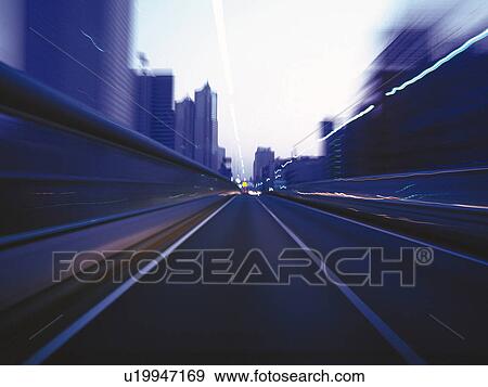 Stock Photo -  a Highway, Surrounded By Buildings, Front View, Blurred Motion, Long Exposure. Fotosearch