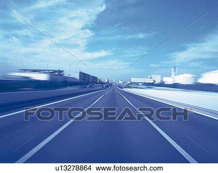 Picture -  a Highway Under a Blue Sky, Front View, Blurred Motion, Toned Image. Fotosearch