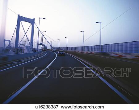 Stock Photo -  a Highway Under a Light Blue Sky. Fotosearch