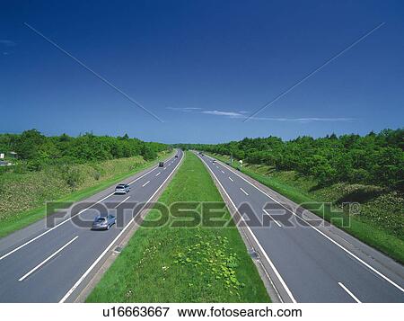 a Highway With Several Cars Driving on it Surrounded By a Green Environment, High Angle View View Large Photo Image Stock Photo - a Highway With Several Cars Driving on it Surrounded By a Green Environment, High Angle View. Fotosearch