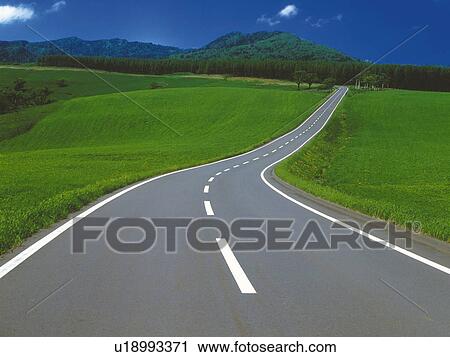 a Mountain Path Surrounded By a Huge Flat Green Land Under a Blue Sky, High Angle View View Large Photo Image Stock Image - a Mountain Path Surrounded By a Huge Flat Green Land Under a Blue Sky, High Angle View. Fotosearch