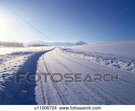 Picture -  a Road Covered With Snow, Surrounded By a Snowy Landscape, Copy Space. Fotosearch