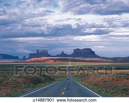 Stock Image -  an Asphalt Road, Heading to Several Red Rocks, High Angle View. Fotosearch
