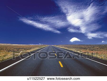 an Asphalt Road Surrounded By a Flat Land Under a Blue Sky, Front View View Large Photo Image Stock Photo - an Asphalt Road Surrounded By a Flat Land Under a Blue Sky, Front View. Fotosearch