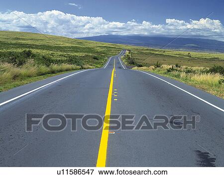 Stock Photo -  an Asphalt Road, Surrounded By a Green Flat Land, High Angle View. Fotosearch