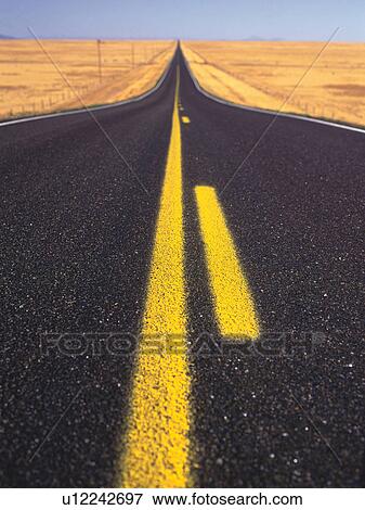 Stock Photo -  an Asphalt Road With Two Yellow Lines, High Angle View. Fotosearch