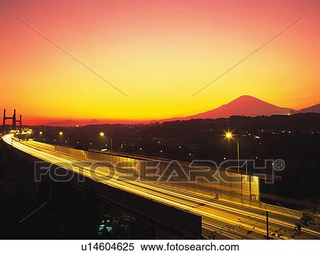 an Illuminated Highway By Sunset, the Mt. Fuji Red From the Colors of the Sun, Side View, Long Exposure, High Angle View, Shizuoka Prefecture, Japan View Large Photo Image Stock Photography - an Illuminated Highway By Sunset, the Mt. Fuji Red From the Colors of the Sun, Side View, Long Exposure, High Angle View, Shizuoka Prefecture, Japan. Fotosearch