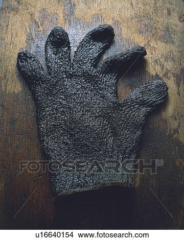 a Brown Glove Soaked in Oil, Lying on a Wooden Floor, High Angle View View Large Photo Image Picture - a Brown Glove Soaked in Oil, Lying on a Wooden Floor, High Angle View. Fotosearch