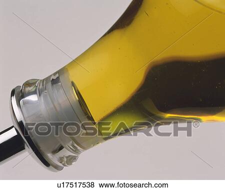 Stock Photo -  a Glass Flask With Some Yellow Oil on the Diagonal, Side View. Fotosearch