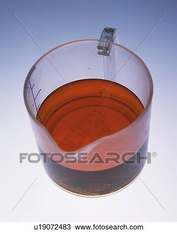 a Measuring Cup Filled With Brown Oil, High Angle View View Large Photo Image Stock Image - a Measuring Cup Filled With Brown Oil, High Angle View. Fotosearch