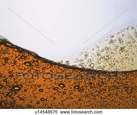 Stock Photography - Brown-colored Oil, Containing a Lot of Bubbles, Front View. Fotosearch